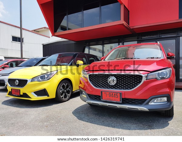 Bangkok, TH -\
MAY 18, 2019: Two new modern red and yellow sport cars parking in\
front of MG company\'s showroom\
building.