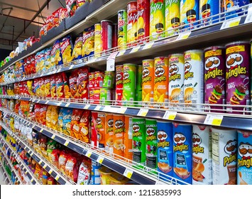 Bangkok, TH -  OCTOBER 14, 2018: Potato Chips And Various Colorful Snack Foods In Supermarket Shelf That Are The Cause Of An Increase Fat Person.