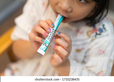 Bangkok / Thailand - 04 19 2020 :Little Girl Eat PB Assist Jr Is A Powdered Probiotic Supplement Designed For Children Or Adults Who Have Trouble Swallowing Pills.doTTERA Products From UTAH.