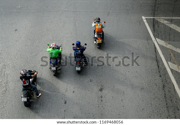 BANGKOK,\
THAILAND - 12 AUG 2018 -Blur motion people on motorcycles are\
moving on road bangkok (Aerial photo, top\
view)