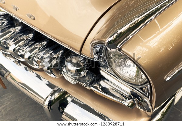 BANGKOK, THAILAND - 12 DECEMBER 2018; DeSoto (De\
Soto) is classic American automobile. Vintage car background. Close\
up of headlight & classic design bumper. Retro car wallpaper.\
Restoration concept.
