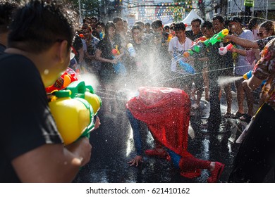 BANGKOK, THAILAND - 13 April 2017 :Play with water gun water gun was the splashing water on each other in Songkran Water Festival at Siam Square, guy cosplay dress up as superman.