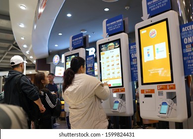 BANGKOK, THAILAND - 13 DEC 2019: People Using Self-ordering Kiosk At Burger King Store. Burger King Serve More Than 11 Million Guests Per Day In 91 Countries And Territories Around The World.