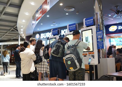 BANGKOK, THAILAND - 13 DEC 2019: People Using Self-ordering Kiosk At Burger King Store. Burger King Serve More Than 11 Million Guests Per Day In 91 Countries And Territories Around The World.