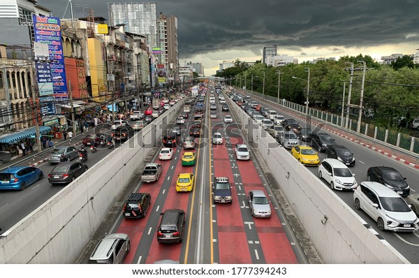Bangkok Thailand - 16/07/2020: In the evening, after\
finish work there was going rain, black cloud at Ngamwongwan Road,\
Kaset Intersection there was a problem of traffic always even.It\'s\
going to rain