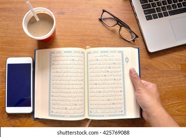 Bangkok, Thailand, 17 May 2016 : Reading the Holy Quran (Islamic Book) on Wooden table