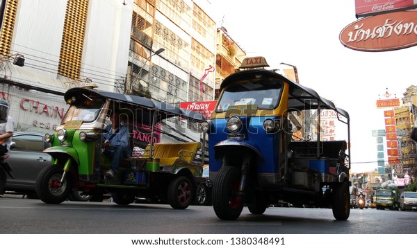 BANGKOK, THAILAND - 18 MARCH, 2019:\
Tuk tuks on street of Asian city. Colorful auto rickshaws riding on\
asphalt road on busy street of Chinatown in\
Bangkok