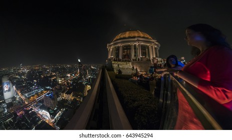 Bangkok, Thailand - 2017: Lebua and Sirocco bar at State Tower in Silom district at night. This bar was included in the Hangover movies,panoramic view from the sky bar at night over the city Bangkok