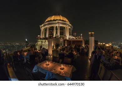 Bangkok, Thailand - 2017: Lebua and Sirocco bar at State Tower in Silom district at night. This bar was included in the Hangover movies,panoramic view from the sky bar at night over the city Bangkok