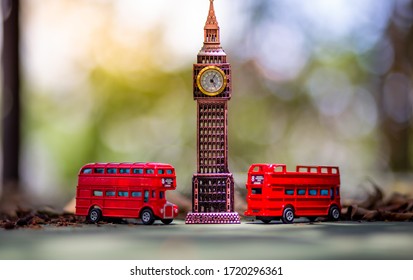 Bangkok, Thailand - 24 April 2020:Toys that represent two of the main symbols of the city of London, red bus and The London famous Big Ben model on blurred background. 