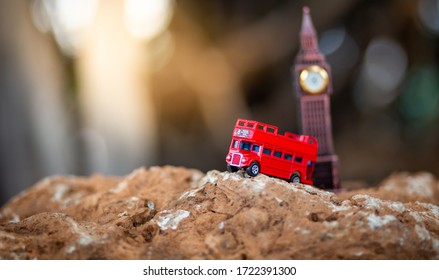 Bangkok, Thailand - 24 April 2020:Toys that represent two of the main symbols of the city of London, red bus and The London famous Big Ben model on blurred background.