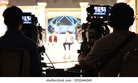 Bangkok, THAILAND - 24 February 2021 : A cameraman's back view with a high quality television camera in television production.