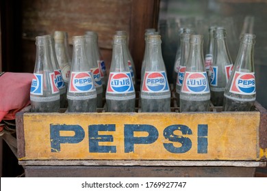 Bangkok, Thailand - 24 March 2019: Old Pepsi bottle in a crate, with Thai Alphabet of 'Pepsi'.  It is a carbonated soft drink manufactured by PepsiCo.