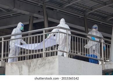 Bangkok Thailand 25 Jul 2021: Por-Tek-Teung Staff were wraping human corpse who died from COVID - 19.