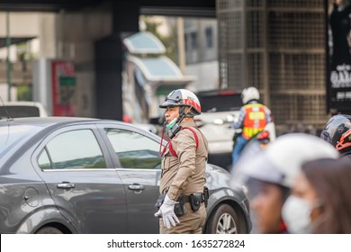 Bangkok, Thailand, 4th February 2020 - Thai police officer diverting the traffic.