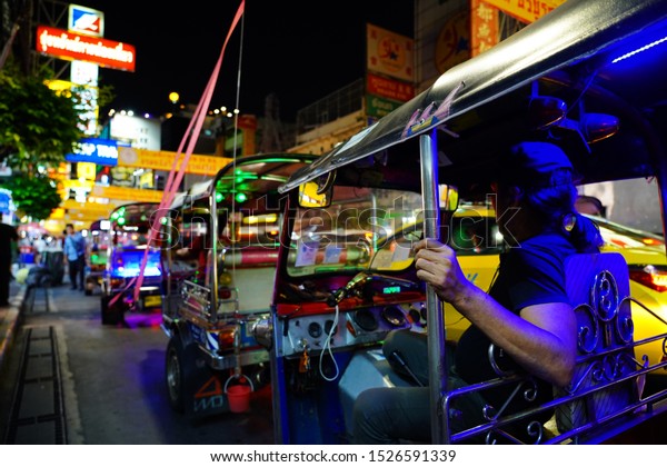 Bangkok, Thailand - 5/10/19 :  Famous moto-taxi
called tuk-tuk is a landmark of the city and popular transport, Tuk
tuk on the street in Chinatown, street food night market in bangkok
thailand.