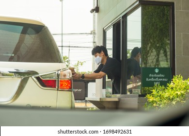 Bangkok Thailand 6 Apr 2020 - Staff With Protective Mask Serving Coffee To Customer At Drive Thru Counter During Coronavirus Outbreak