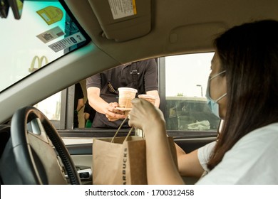 Bangkok Thailand 6 Apr 2020 - At Starbucks Staff Serving Coffee To Customer At Drive Thru Counter During Coronavirus Outbreak.