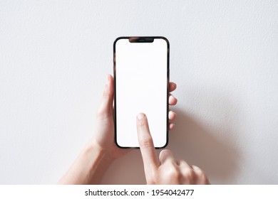 Bangkok, Thailand - Apr 10, 2021: Close Up Hand Holding Black Smartphone IPhone 12 Pro Max With White Screen. Isolated On White Background. Mobile Phone Frameless Design Concept.