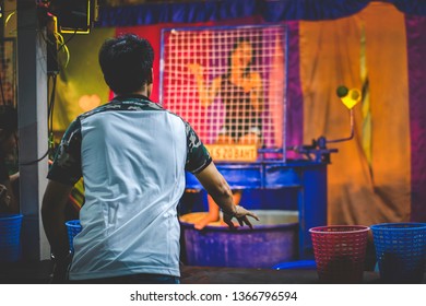 Bangkok, Thailand - Apr 11 2019 : A Man Play Dunk Tank Girl Game At Night Market.