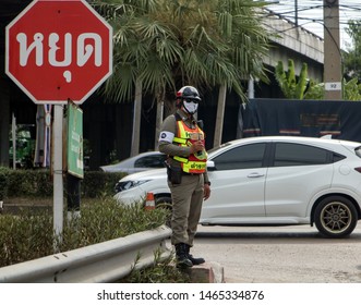 BANGKOK, THAILAND, APR 27 2019, A Traffic Cop Directing Traffic On The Road. Policeman Control Traffic At Crossroads In City Street. 