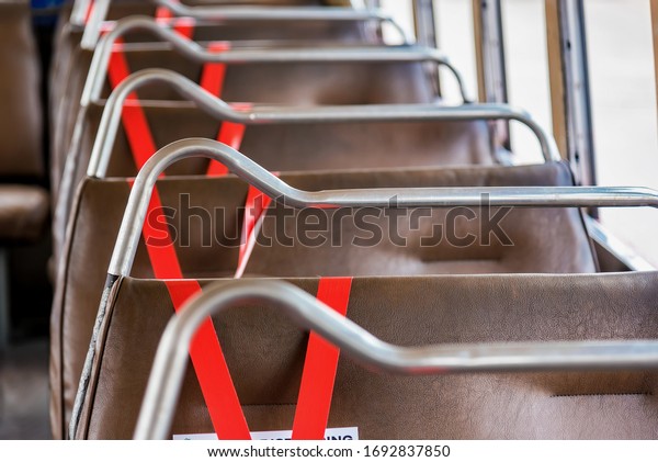 Bangkok, Thailand - April, 01, 2020 :\
Seat on public buses with signs social distancing protect for\
pandemic of disease virus Covid-19 in Thailand,Covid, Protect,Stay\
at home,Stop\
infection,national