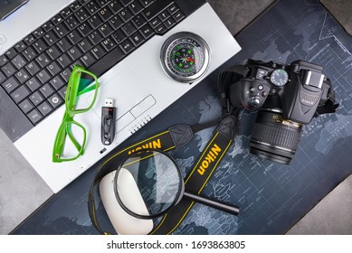 Bangkok, Thailand - April, 04, 2020 :  Green Frame Glasses, Notebook Computer And Dslr Nikon D5300 Isolated On The Table, Stone Pattern.