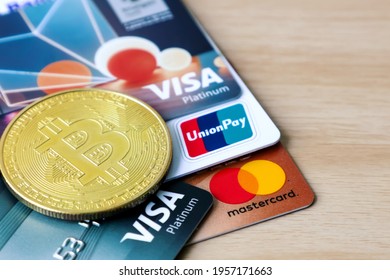 Bangkok, Thailand - April 14, 2021 : Bitcoin Golden Coin On Visa , Master , Union Pay Debit And Credit Card , Symbol Of Digital Currency Cryptocurrency, 