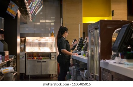 BANGKOK, THAILAND - APRIL 16: Mcdonald's Employee Takes Order On POS System Behind The Counter In The Mall Bangkae In Bangkok On April 16, 2018.