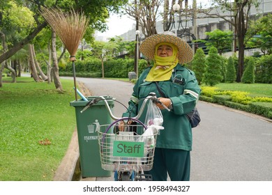 Bangkok Thailand ; April 19,2021 Worker Ready To Work For A Long Distance With The Staff Bicycle And Other Equipment Including Trash Can And Broom In The Central Park                           