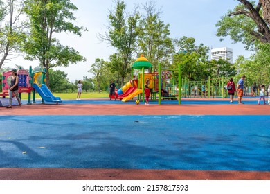 Bangkok, Thailand - April 24, 2022 : Children and family happily have fun at playground in public park in Bangkok, Thailand on April 24, 2022.