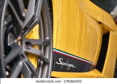 BANGKOK, THAILAND - APRIL 25, 2019: Car Wash & Car Detail Concept. Side View Of Wet Bright Yellow Lamborghini Supercar. Water Drop & Beading Created By Ceramic Coat & Paint Sealant. Shallow DOF. 