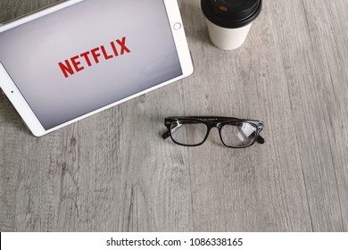 BANGKOK, THAILAND - April 28, 2018 : Netflix App Icon On Ipad Tablet Screen With Eyeglasses And Coffee. Netflix Is An International Leading Subscription Service For Watching Movies And TV Series.