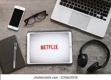 BANGKOK, THAILAND - April 28, 2018 : Netflix App Icon On Ipad Tablet Screen With Headphone And Laptop. Netflix Is An International Leading Subscription Service For Watching Movies And TV Series.