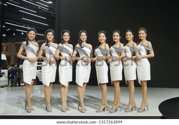 Bangkok, Thailand - April 3, 2019 : Preety woman\
with All new Toyota Supra show case on stage at BANGKOK\
INTERNATIONAL MOTOR SHOW 2019            \
