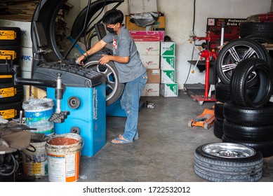 Bangkok, Thailand - April 4, 2020 : Unidentified Car Mechanic Or Serviceman Wheel Alignment And Tire Balance Checking Car Wheel For Fix And Repair Suspension Problem At Car Garage Or Repair Shop