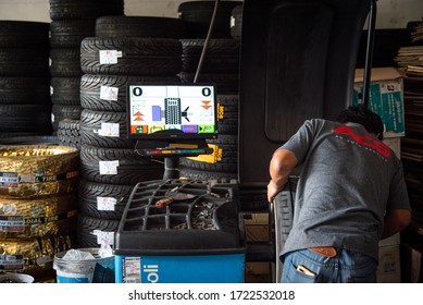 Bangkok, Thailand - April 4, 2020 : Unidentified Car Mechanic Or Serviceman Wheel Alignment And Tire Balance Checking Car Wheel For Fix And Repair Suspension Problem At Car Garage Or Repair Shop