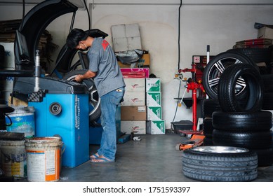 Bangkok, Thailand - April 4, 2020 : Unidentified Car Mechanic Or Serviceman Wheel Alignment And Tire Balance Checking Car Wheel For Fix And Repair Suspension Problem At Car Garage Or Repair Shop