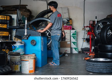 Bangkok, Thailand - April 4, 2020 : Unidentified Car Mechanic Or Serviceman Wheel Alignment And Tire Balance Checking Car Wheel For Fix And Repair Suspension Problem At Car Garage Or Repair Shop