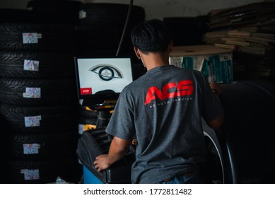 Bangkok, Thailand - April 4, 2020 : Unidentified Car Mechanic Or Serviceman Wheel Alignment And Tire Balance Checking Car Wheel For Fix And Repair Suspension Problem At Car Garage Or Repair Shop