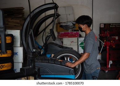 Bangkok, Thailand - April 4, 2020 : Unidentified Car Mechanic Or Serviceman Wheel Alignment And Tire Balance Checking Car Wheel For Fix And Repair Suspension Problem At Car Garage Or Repair Shop