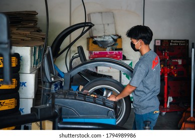 Bangkok, Thailand - April 4, 2020 : Unidentified Car Mechanic Or Serviceman Wheel Alignment And Tire Balance Checking Car Wheel For Fix And Repair Suspension Problem At Car Garage Or Repair Shop