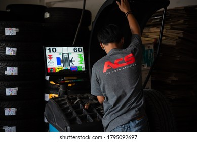 Bangkok, Thailand - April 4, 2020 : Unidentified Car Mechanic Or Serviceman Wheel Alignment And Tire Balance Checking Car Wheel For Fix And Repair Suspension Problem At Car Garage Or Repair Shop