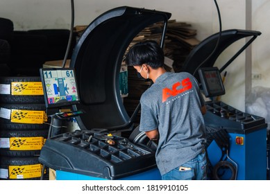 Bangkok, Thailand - April 4, 2020 : Unidentified Car Mechanic Or Serviceman Wheel Alignment And Tire Balance Checking Car Wheel For Fix And Repair Suspension Problem At Car Garage Or Repair Shop