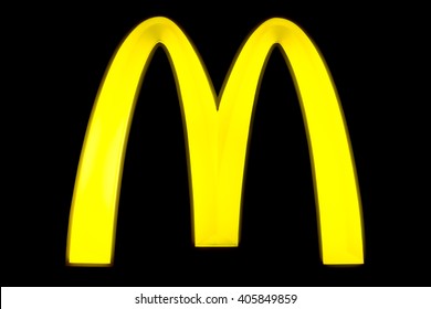 BANGKOK, THAILAND - April 6, 2016:  McDonald's sign with the famous M sign at a black board during evening. McDonald's Corporation is the worlds largest chain of hamburger fast food restaurants