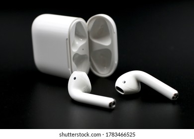 Bangkok , Thailand - April 6,2020 : Air Pods. with Wireless Charging Case. New Airpods 2019 on black background. Airpods.EarPods.