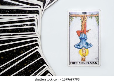 
Bangkok, Thailand- April-3-2020: The Hanged man : Major arcana tarot cards with multiple cards back side surround.