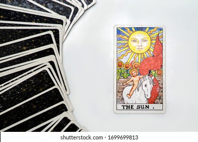 Bangkok, Thailand- April-3-2020:  The Sun : Major arcana tarot cards with multiple cards back side surround.