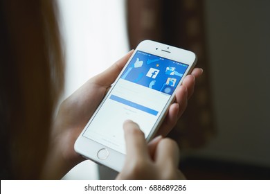 Bangkok, Thailand - August 02, 2017 : hand is pressing the Facebook screen on apple iphone6 ,Social media are using for information sharing and networking.
