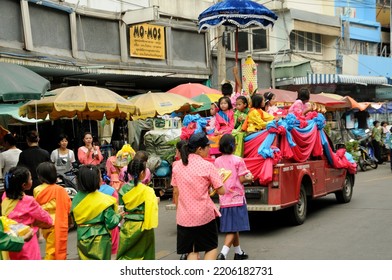 BANGKOK, THAILAND - August 1, 2012. Asahna Bucha Religious School Procession (commemorates Buddha's First Sermon On The Four Noble Truths). Children Carry Gifts For Buddhist Monks Who Begin Fasting.